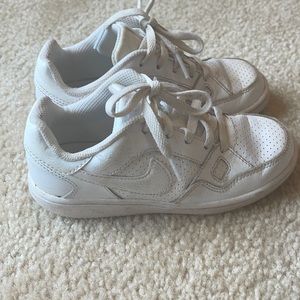 All white Nike little boys sneakers